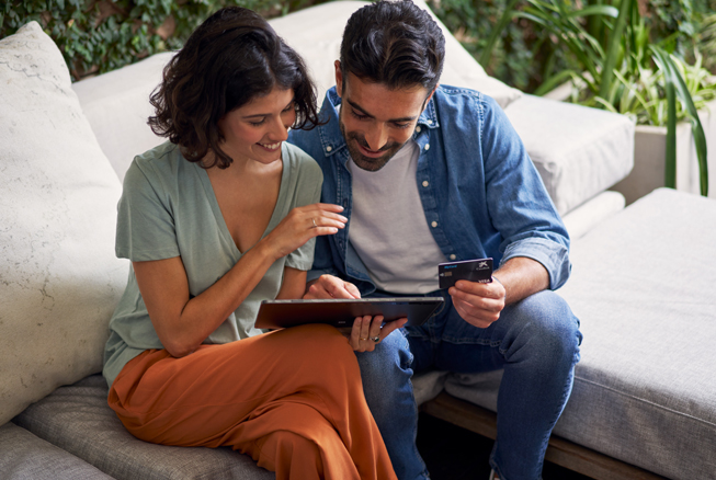 Couple with tablet, payment protection insurance